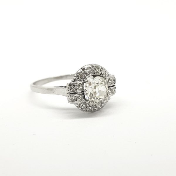 Vintage French Old Cut Diamond Cluster Ring in Platinum; central 0.90 carat old-cut diamond is claw set within a diamond surround which details at the shoulders
