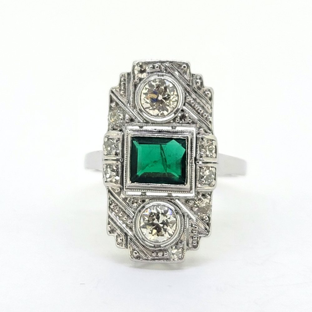 Art Deco Colombian Emerald and Diamond Tablet Plaque Ring, square step-cut Colombian emerald flanked top and bottom by sparkling diamond all within tablet surround accented with smaller diamonds in 18ct white gold