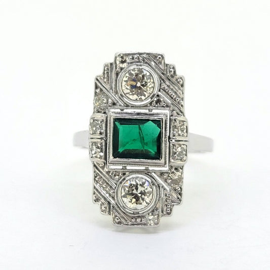 Art Deco Colombian Emerald and Diamond Tablet Plaque Ring, square step-cut Colombian emerald flanked top and bottom by sparkling diamond all within tablet surround accented with smaller diamonds in 18ct white gold