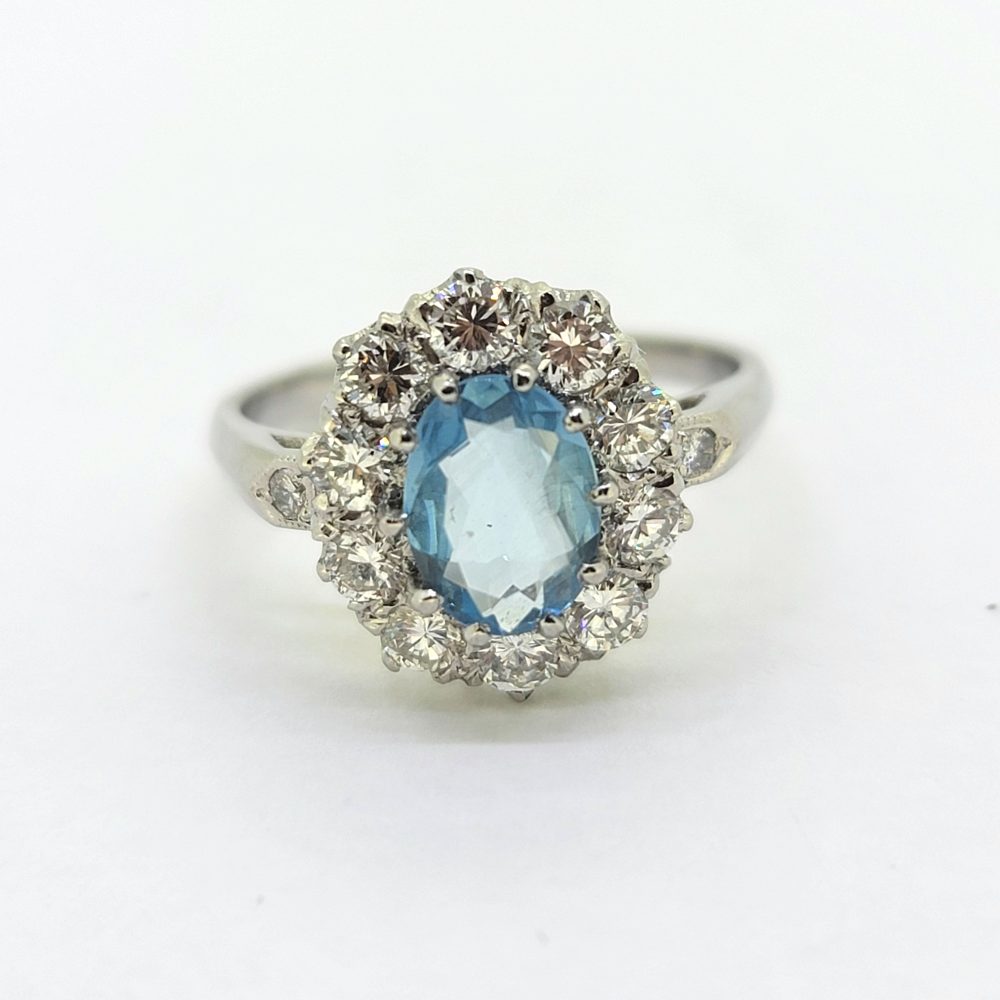 Oval Aquamarine and Diamond Cluster Engagement Ring