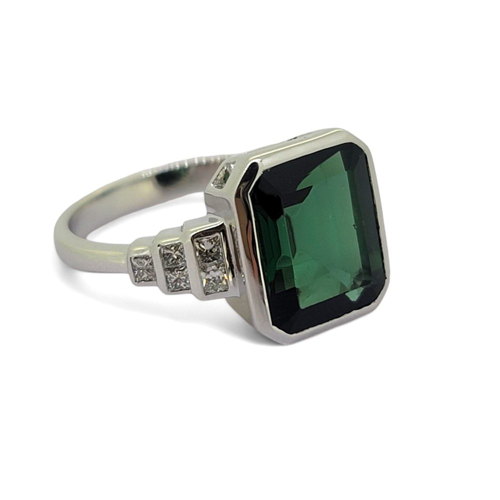 Green Garnet and Diamond Engagement Ring, 4.86ct emerald-cut green garnet accented with graduated stepped diamond shoulders in 18ct white gold