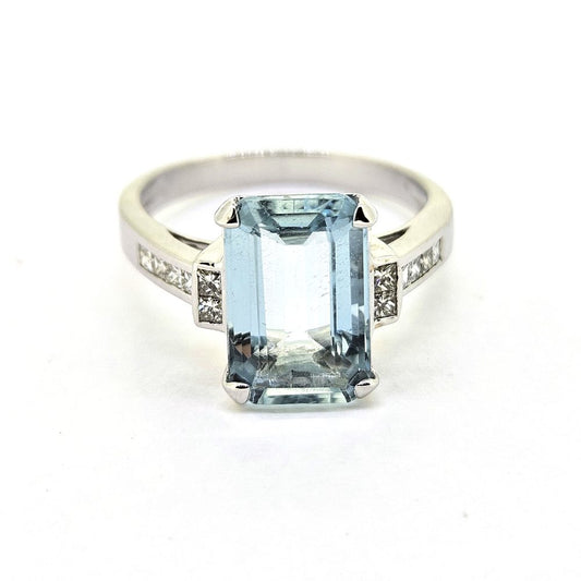3ct Aquamarine and Princess Cut Diamond Engagement Ring, 3.02ct emerald-cut aquamarine flanked by square princess-cut diamonds in 18ct white gold