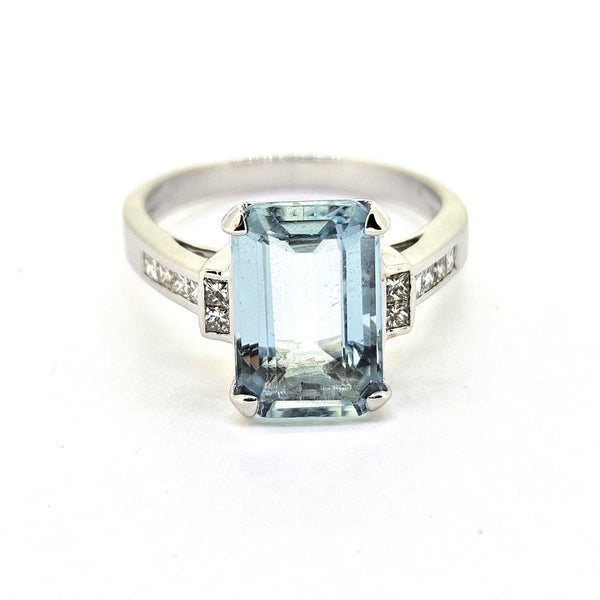 3ct Aquamarine and Princess Cut Diamond Engagement Ring, 3.02ct emerald-cut aquamarine flanked by square princess-cut diamonds in 18ct white gold