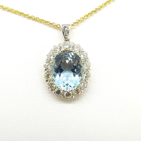 Aquamarine and Diamond Oval Cluster Pendant; 7ct oval aquamarine within a 1.70ct brilliant-cut diamond surround, in 18ct gold