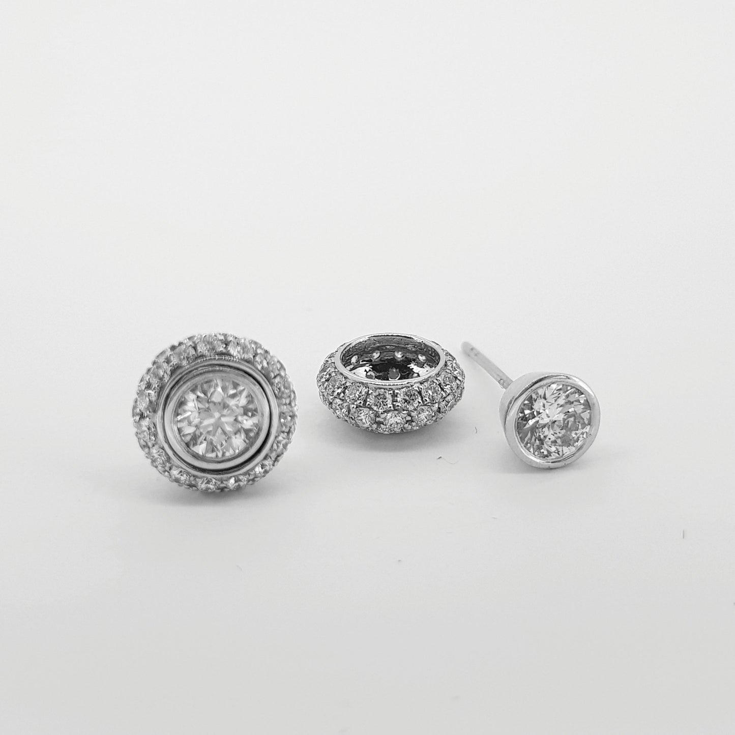 A pair of diamond round cluster earrings in white gold