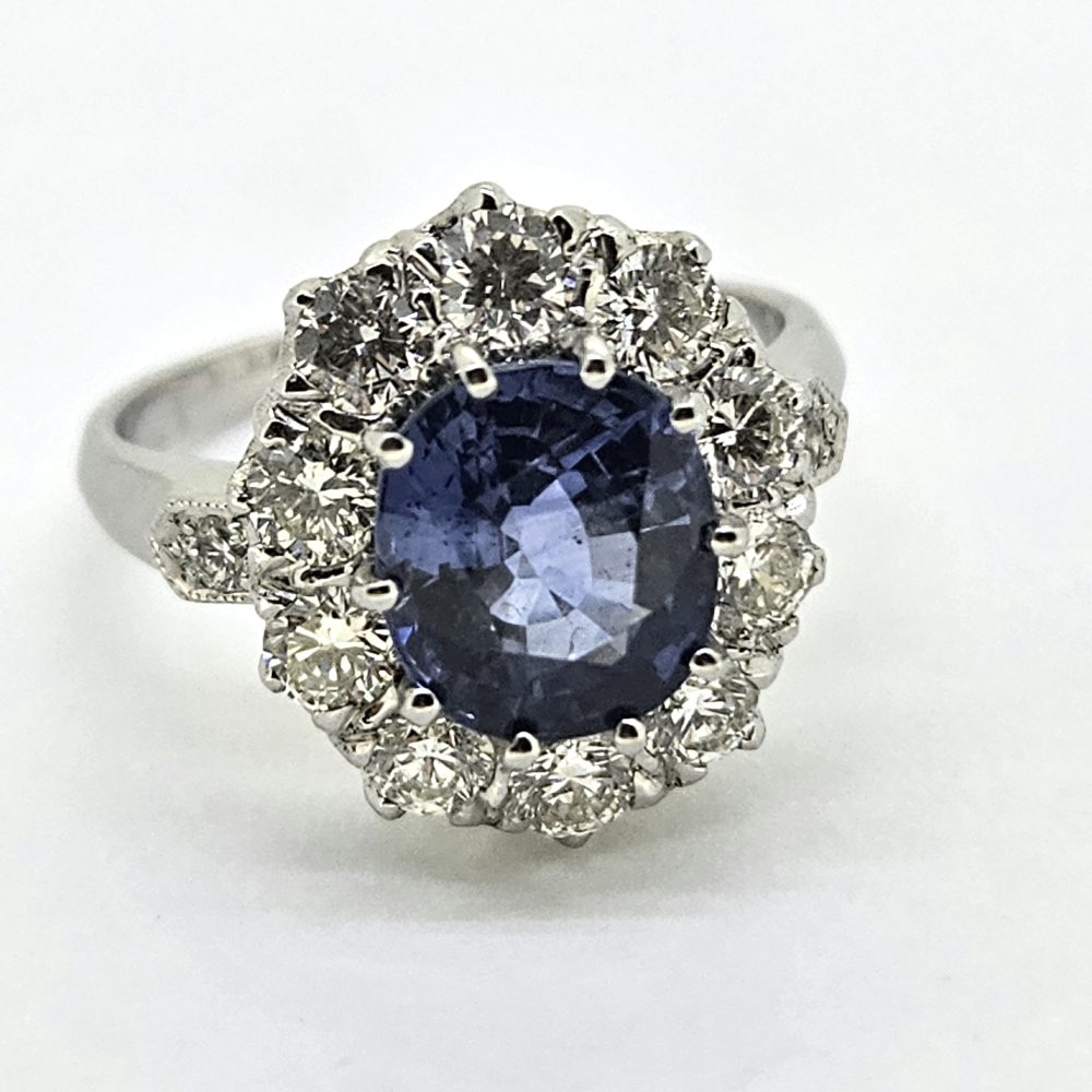 3.25ct Sapphire and Diamond Cluster Engagement Ring in Platinum, 3.25ct blue sapphire surrounded by 1.35 carats of sparkling brilliant-cut diamonds