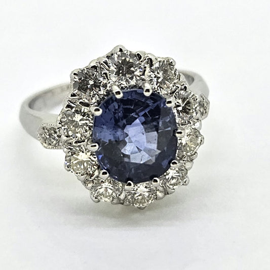 3.25ct Sapphire and Diamond Cluster Engagement Ring in Platinum, 3.25ct blue sapphire surrounded by 1.35 carats of sparkling brilliant-cut diamonds