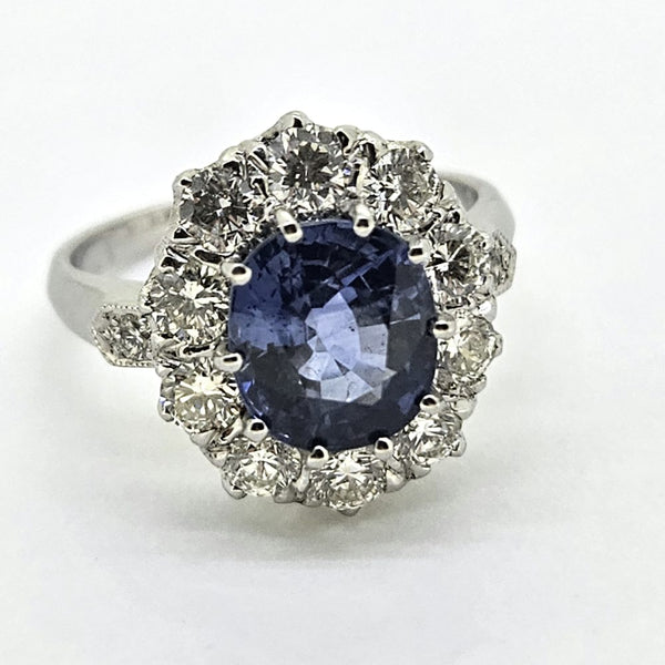 3.25ct Sapphire and Diamond Cluster Engagement Ring in Platinum, 3.25ct blue sapphire surrounded by 1.35 carats of sparkling brilliant-cut diamonds
