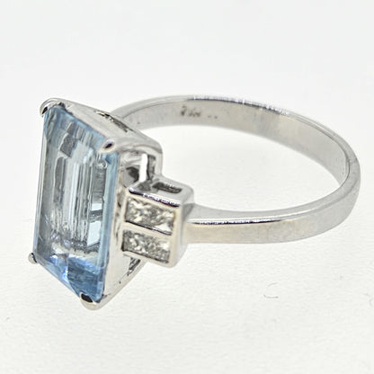 An emerald cut aquamarine and diamond ring in white gold