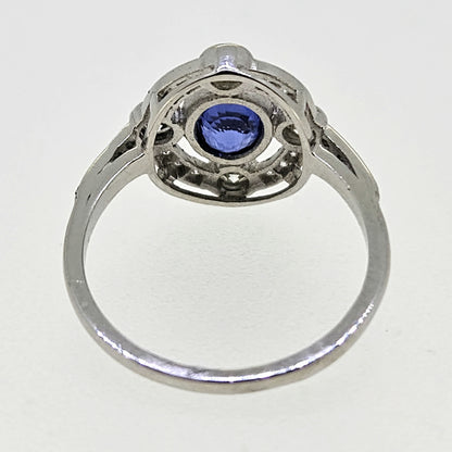 An oval sapphire and round diamond open cluster ring in platinum
