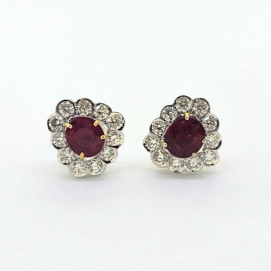 Ruby and Diamond Floral Cluster Stud Earrings, 1.74cts oval red rubies surrounded by 0.75cts sparkling round brilliant-cut diamonds in 18ct white gold