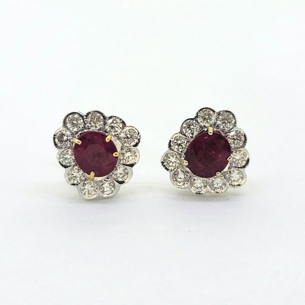 Ruby and Diamond Floral Cluster Stud Earrings, 1.74cts oval red rubies surrounded by 0.75cts sparkling round brilliant-cut diamonds in 18ct white gold
