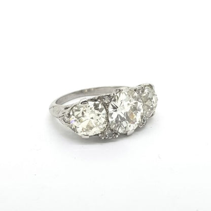 Vintage 1950s Diamond Three Stone Ring, 5.50 carat total, three brilliant-cut diamonds claw-set with delicate diamond accents, in 18ct white gold