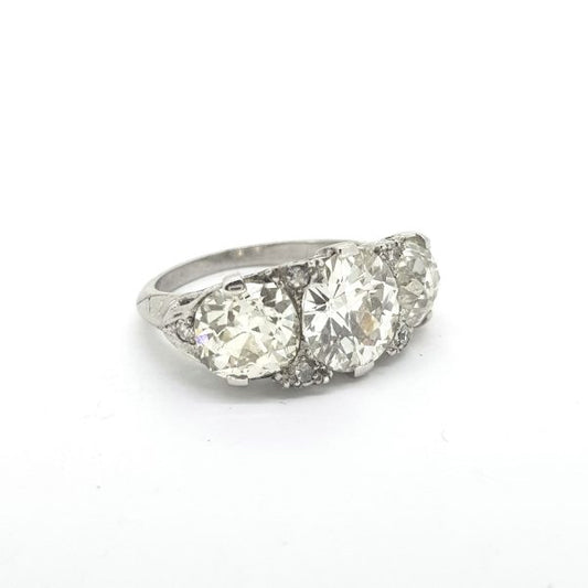 Vintage 1950s Diamond Three Stone Ring, 5.50 carat total, three brilliant-cut diamonds claw-set with delicate diamond accents, in 18ct white gold