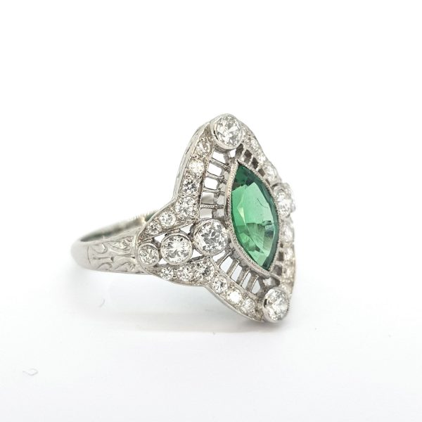 Columbian Emerald and Diamond Navette Cluster Ring; featuring a marquise-cut emerald surrounded by sparkling brilliant-cut diamonds, in 18ct white gold