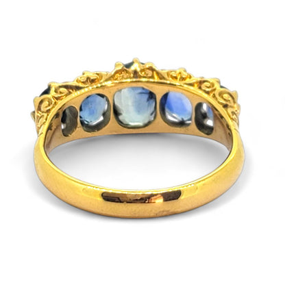 Antique Style Natural Sapphire Five Stone Ring, composed of five graduated oval blue sapphire claw set and mounted in 18ct yellow gold