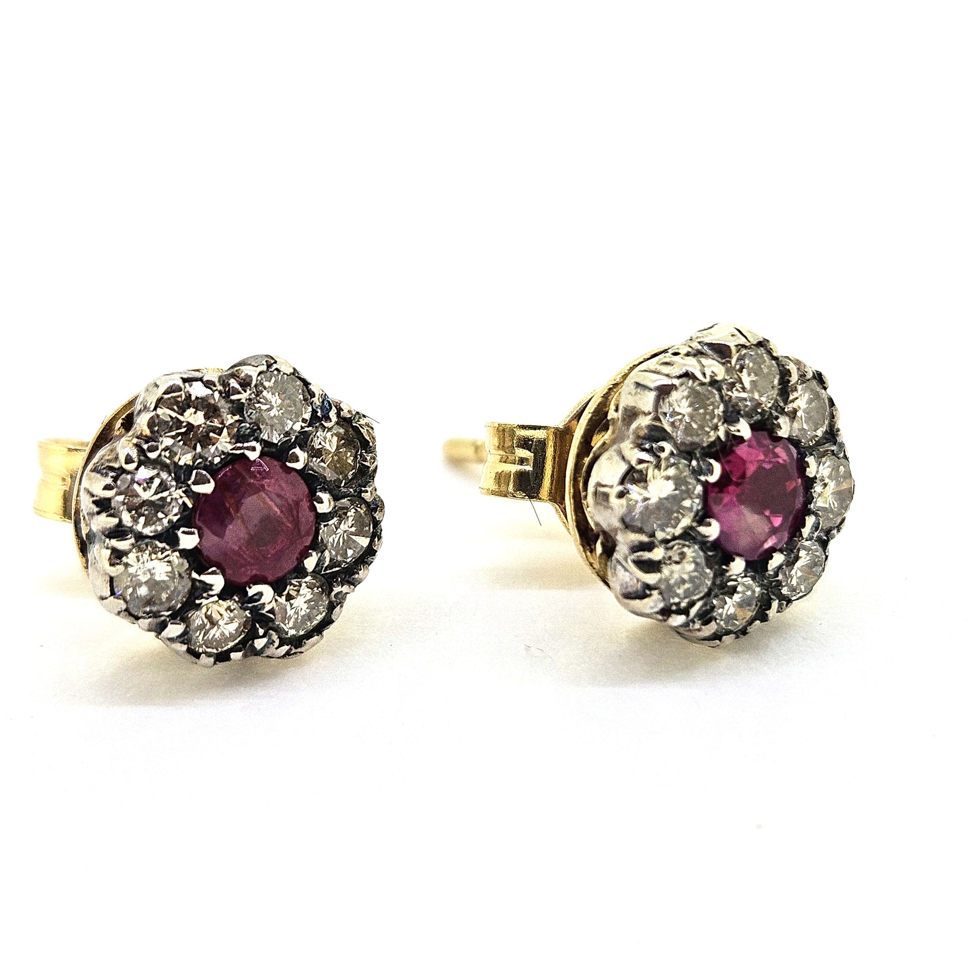 Ruby and diamond cluster earrings in gold and silver, on a white background