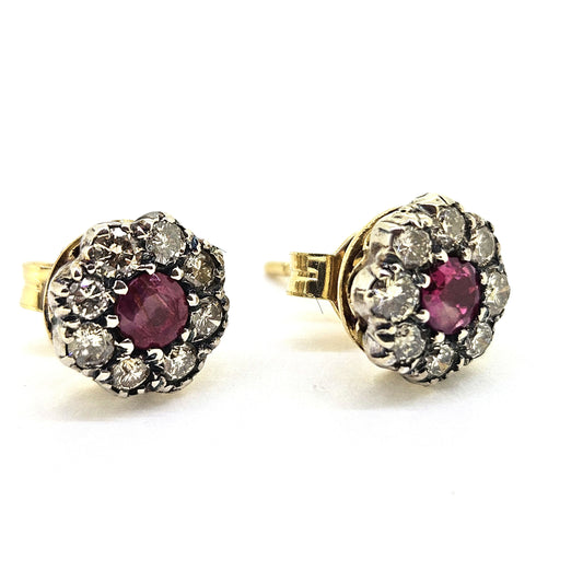 Ruby and diamond cluster earrings in gold and silver, on a white background
