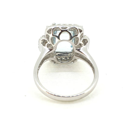 Aquamarine and Diamond Cluster Dress Ring, 3.19ct emerald-shaped aquamarine surrounded by round brilliant-cut diamonds with princess-cut diamonds to the sides in 18ct white gold