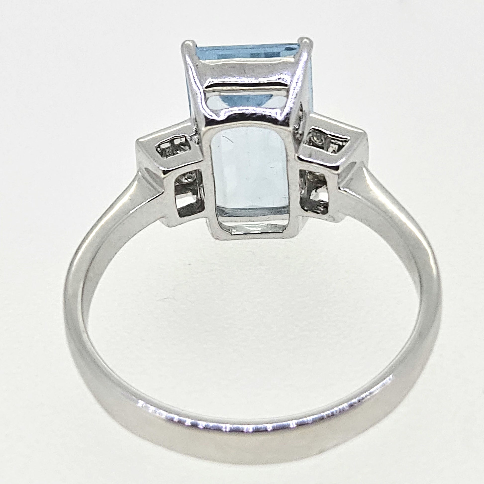 An emerald cut aquamarine and diamond ring in white gold