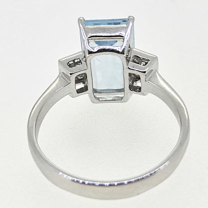 An emerald cut aquamarine and diamond ring in white gold