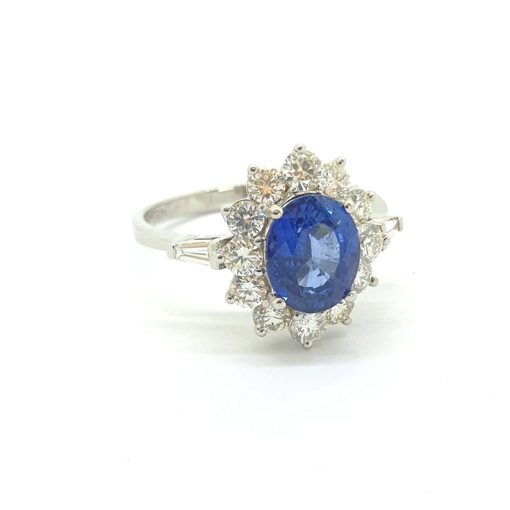 2.10ct Oval Sapphire and Diamond Cluster Engagement Ring with tapered baguette diamond shoulders