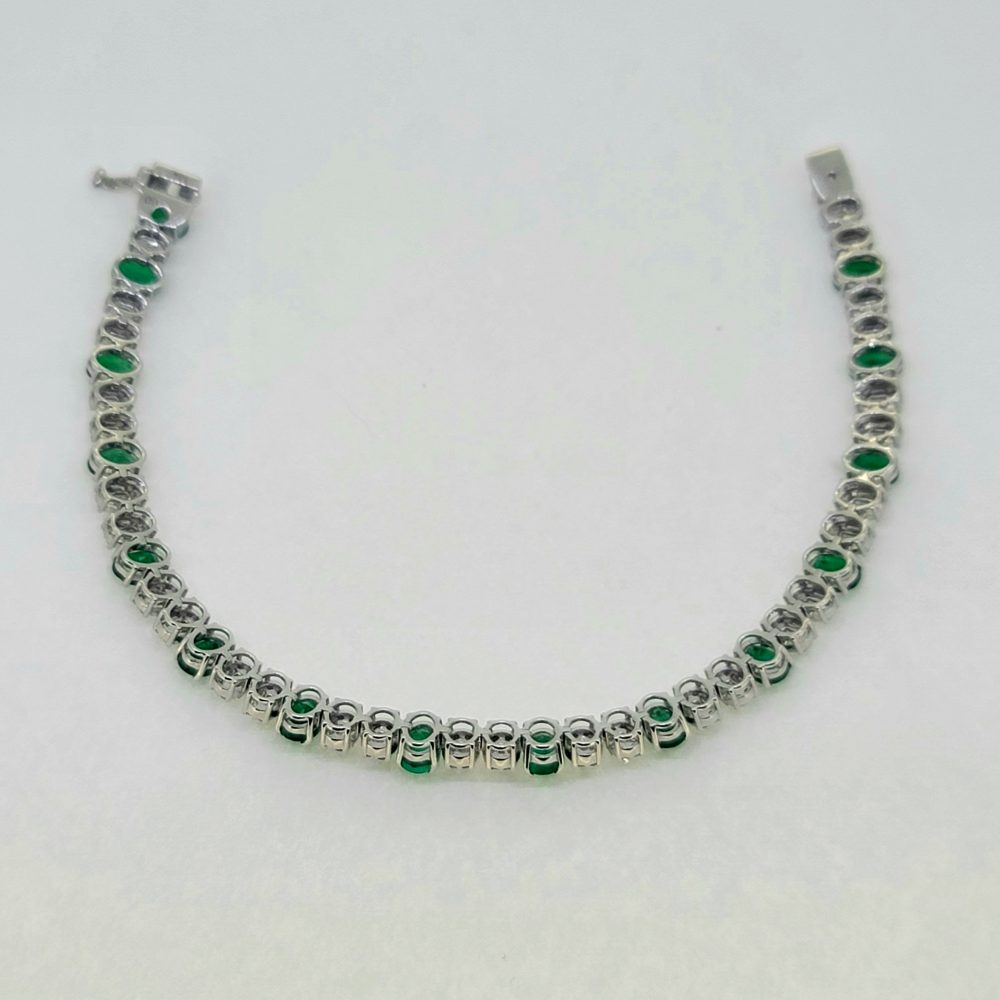 Oval Cut 6.72ct Emerald and Diamond Line Tennis Bracelet in 18ct White Gold