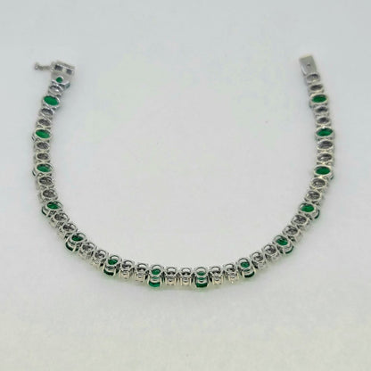 Oval Cut 6.72ct Emerald and Diamond Line Tennis Bracelet in 18ct White Gold