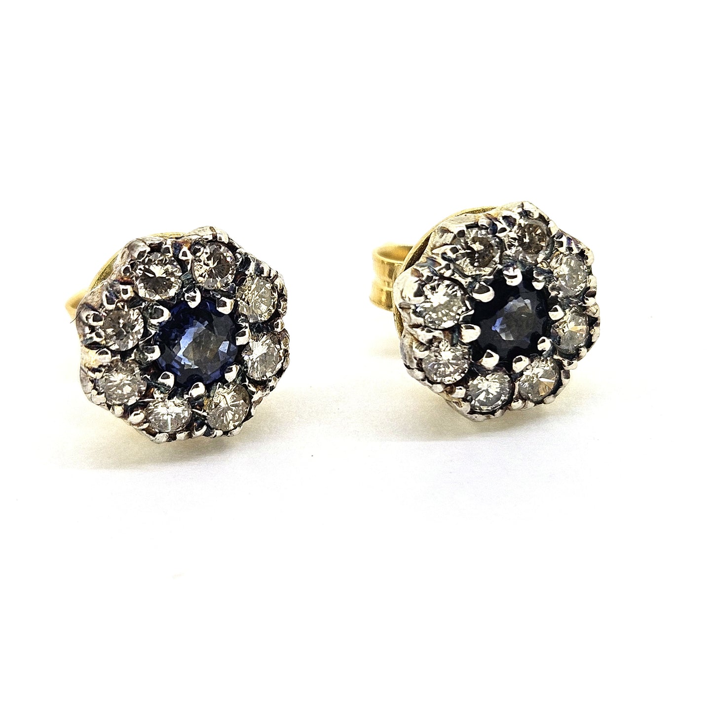 Sapphire and diamond cluster stud earrings in silver and 18ct yellow gold, on a white background