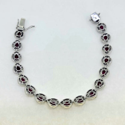 13cts Ruby and Diamond Cluster Bracelet, 13.00 carats of rubies each surrounded by a halo of sparkling round brilliant-cut diamonds in 18ct white gold