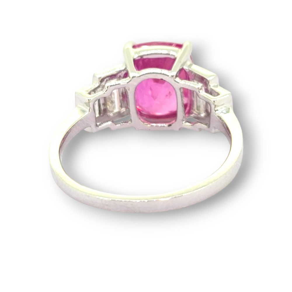 Natural Pink Sapphire and Baguette Diamond Engagement Ring, 3.90ct oval natural pink sapphire flanked by graduated stepped baguette-cut diamonds in 18ct white gold