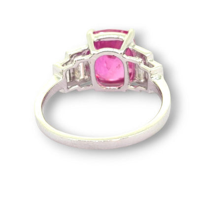 Natural Pink Sapphire and Baguette Diamond Engagement Ring, 3.90ct oval natural pink sapphire flanked by graduated stepped baguette-cut diamonds in 18ct white gold