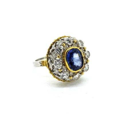 Sapphire and Diamond Cluster Dome Dress Ring; central 5.20ct oval sapphire within a 1ct diamond-set openwork surround, in 18ct white gold with yellow gold accents