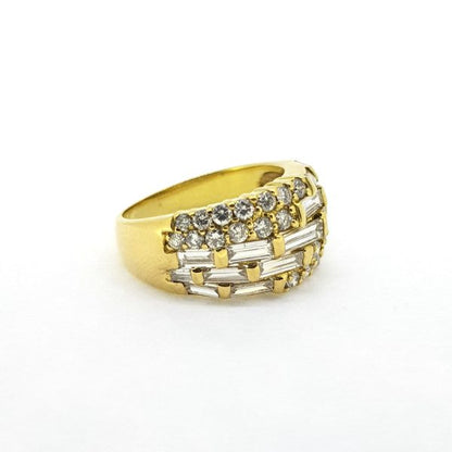 Modern Baguette and Brilliant Cut Diamond Dress Ring; 18ct yellow gold band set with brilliant and baguette-cut diamonds in eye-catching off-set asymmetrical pattern