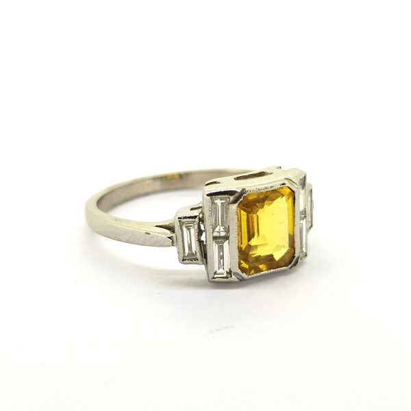 Yellow Sapphire and Diamond Dress Ring in 18ct White Gold; 1.40ct emerald-cut yellow sapphire flanked by 0.35cts baguette-cut diamonds in stepped arrangement