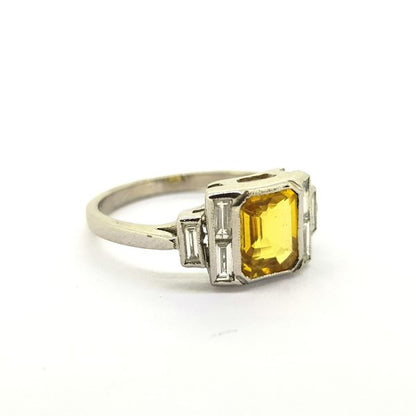 Yellow Sapphire and Diamond Dress Ring in 18ct White Gold; 1.40ct emerald-cut yellow sapphire flanked by 0.35cts baguette-cut diamonds in stepped arrangement