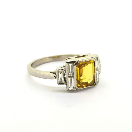 Yellow Sapphire and Diamond Dress Ring in 18ct White Gold; 1.40ct emerald-cut yellow sapphire flanked by 0.35cts baguette-cut diamonds in stepped arrangement