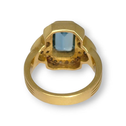 4.4ct Santa Maria Aquamarine and Diamond Cluster Dress Ring, 4.40ct emerald-cut Santa Maria aquamarine flanked by pear-cut diamonds all within diamond border in 18ct yellow gold