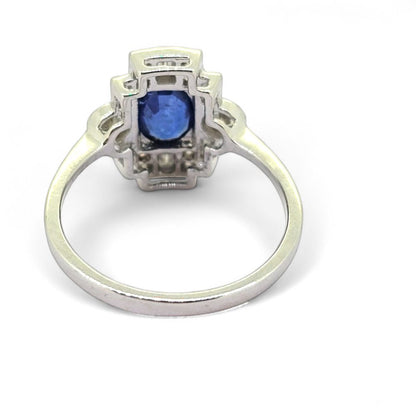 Sapphire and Diamond Cluster Plaque Ring, 0.99ct oval blue sapphire central to 0.55ct brilliant and baguette-cut diamond tablet surround in 18ct white gold