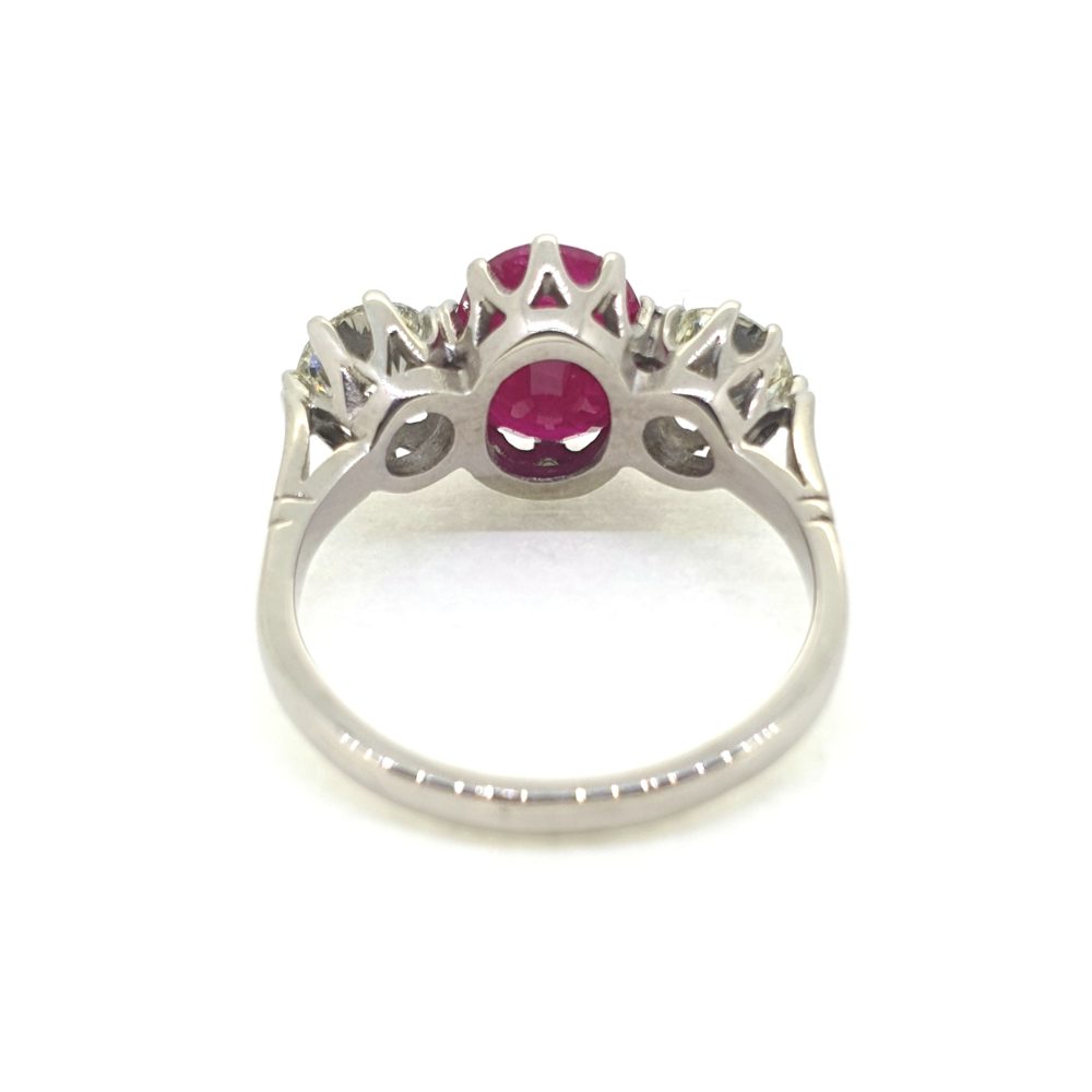3.75ct Oval Ruby and Diamond Three Stone Engagement Ring in Platinum, central 3.75ct oval red ruby flanked by 1.44cts round brilliant-cut diamonds