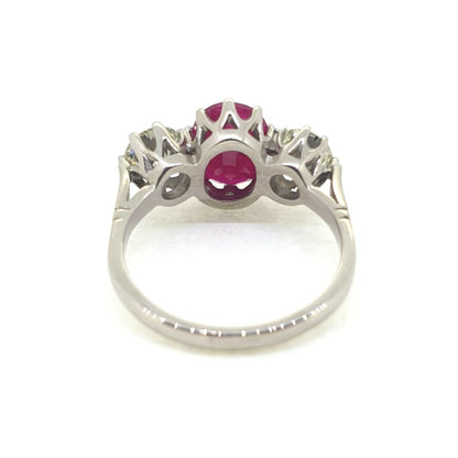 3.75ct Oval Ruby and Diamond Three Stone Engagement Ring in Platinum, central 3.75ct oval red ruby flanked by 1.44cts round brilliant-cut diamonds