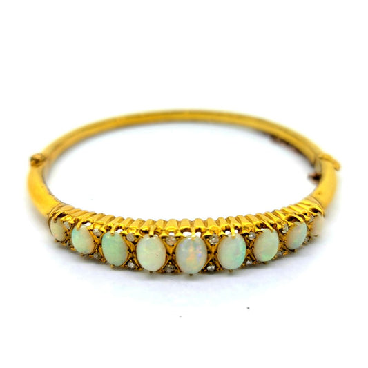 Opal and Diamond Yellow Gold Bangle Bracelet, 18ct yellow gold hinged bangle bracelet set with gently graduating oval cabochon opals with diamond accents