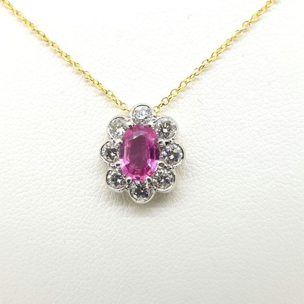 Pink Sapphire and Diamond Oval Cluster Pendant; central 0.70ct oval pink sapphire surrounded by 0.60cts diamonds, collet set in 18ct white gold