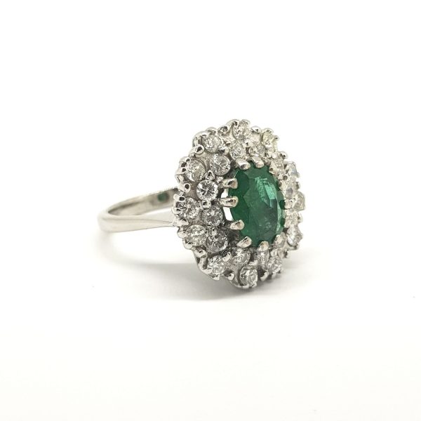 Emerald and Diamond Cluster Ring in 18ct White Gold; central oval faceted emerald within a double diamond surround