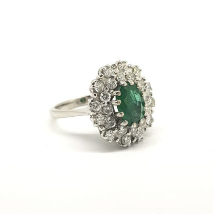 Emerald and Diamond Cluster Ring in 18ct White Gold; central oval faceted emerald within a double diamond surround
