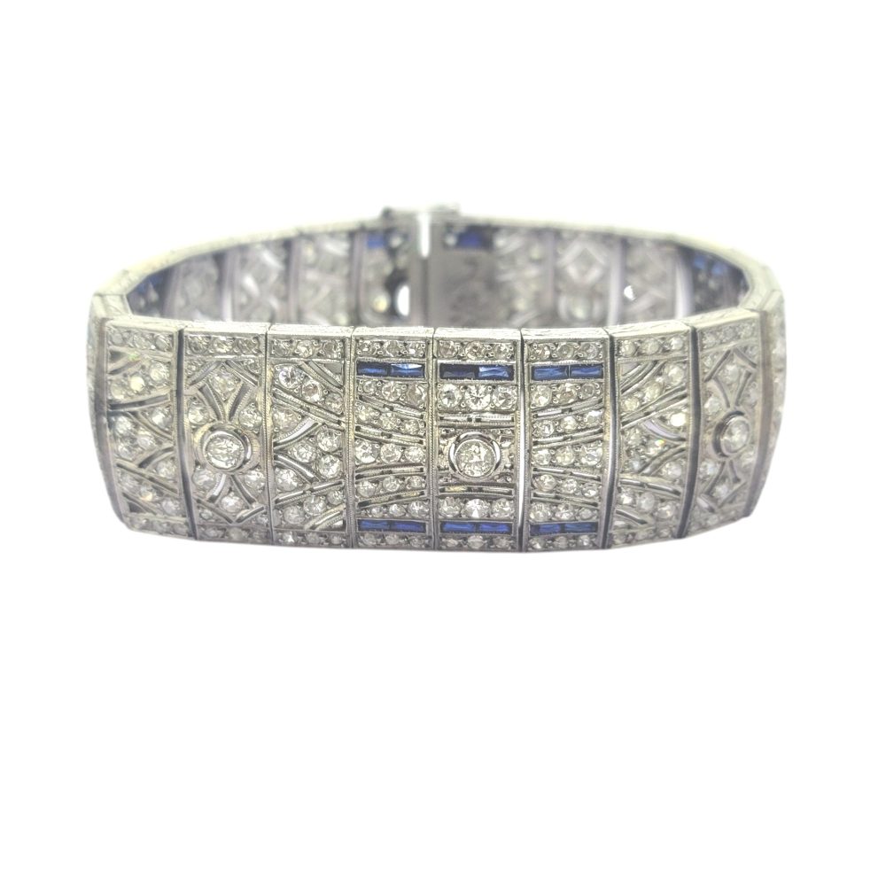 Art Deco Sapphire and Diamond Bracelet in Platinum, wide platinum bracelet set with sparkling diamonds accented with rich blue sapphires Circa 1920s 1930s