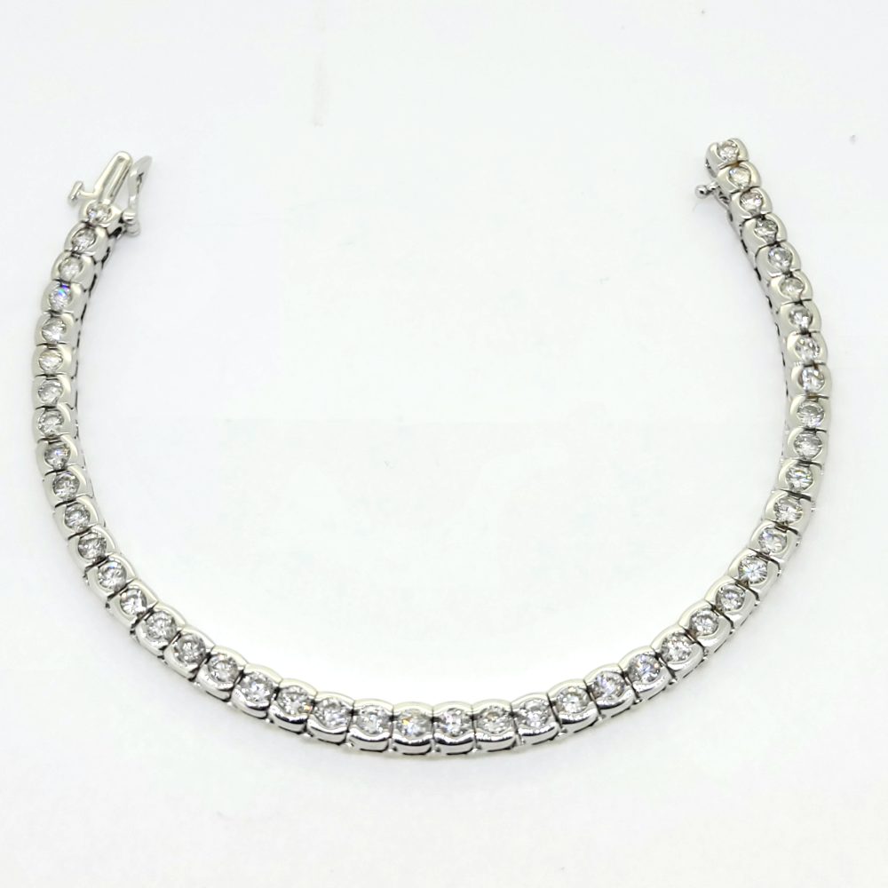 Modern 6.60ct Diamond Line Bracelet in 14ct White Gold, 6.60 carats of round brilliant-cut diamonds in individual bezel settings creating a seamless articulated design