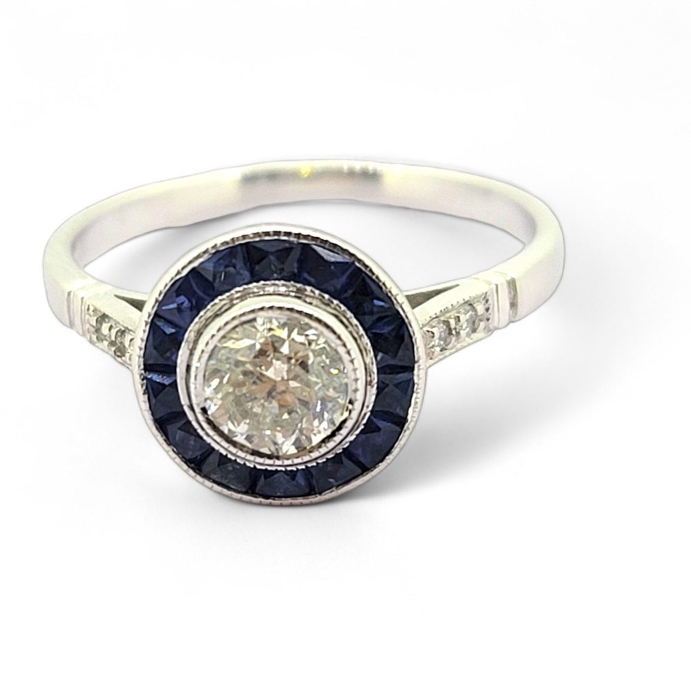 0.53ct Diamond and Sapphire Target Engagement Ring, 0.53ct round brilliant-cut diamonds surrounded by a halo of calibre sapphires in 18ct white gold