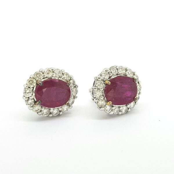 Ruby and Diamond Oval Cluster Stud Earrings; featuring 4.65cts oval faceted rubies surrounded by 1.48cts diamonds, in 18ct white gold