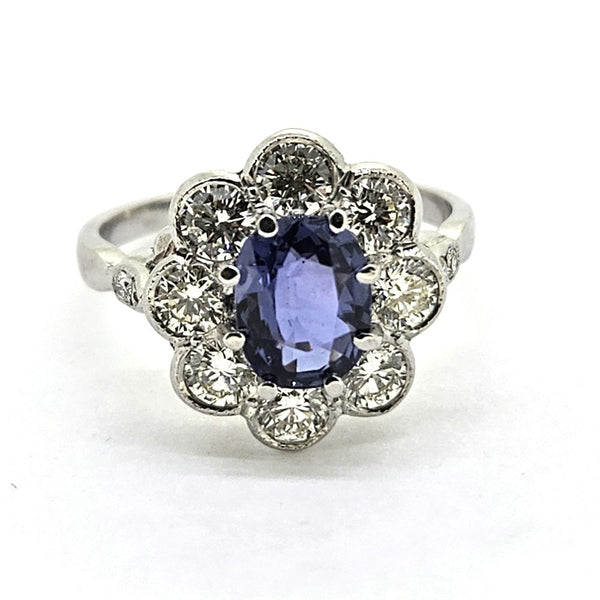 1.60ct Sapphire and Diamond Floral Cluster Engagement Ring in Platinum, 1.60ct oval blue sapphire surrounded by 1.40cts brilliant-cut diamonds in timeless flower cluster design